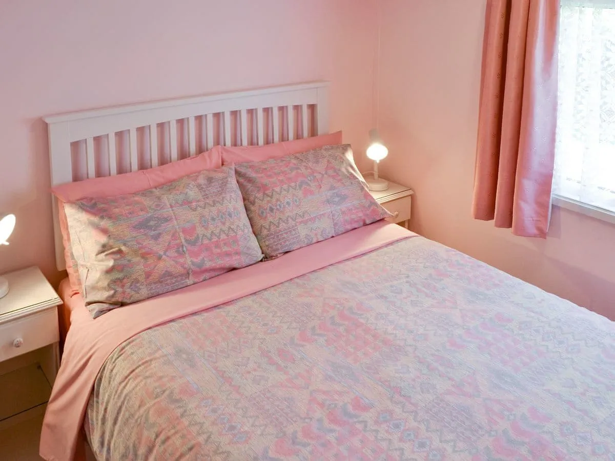 Main double bedroom featuring fresh white linens